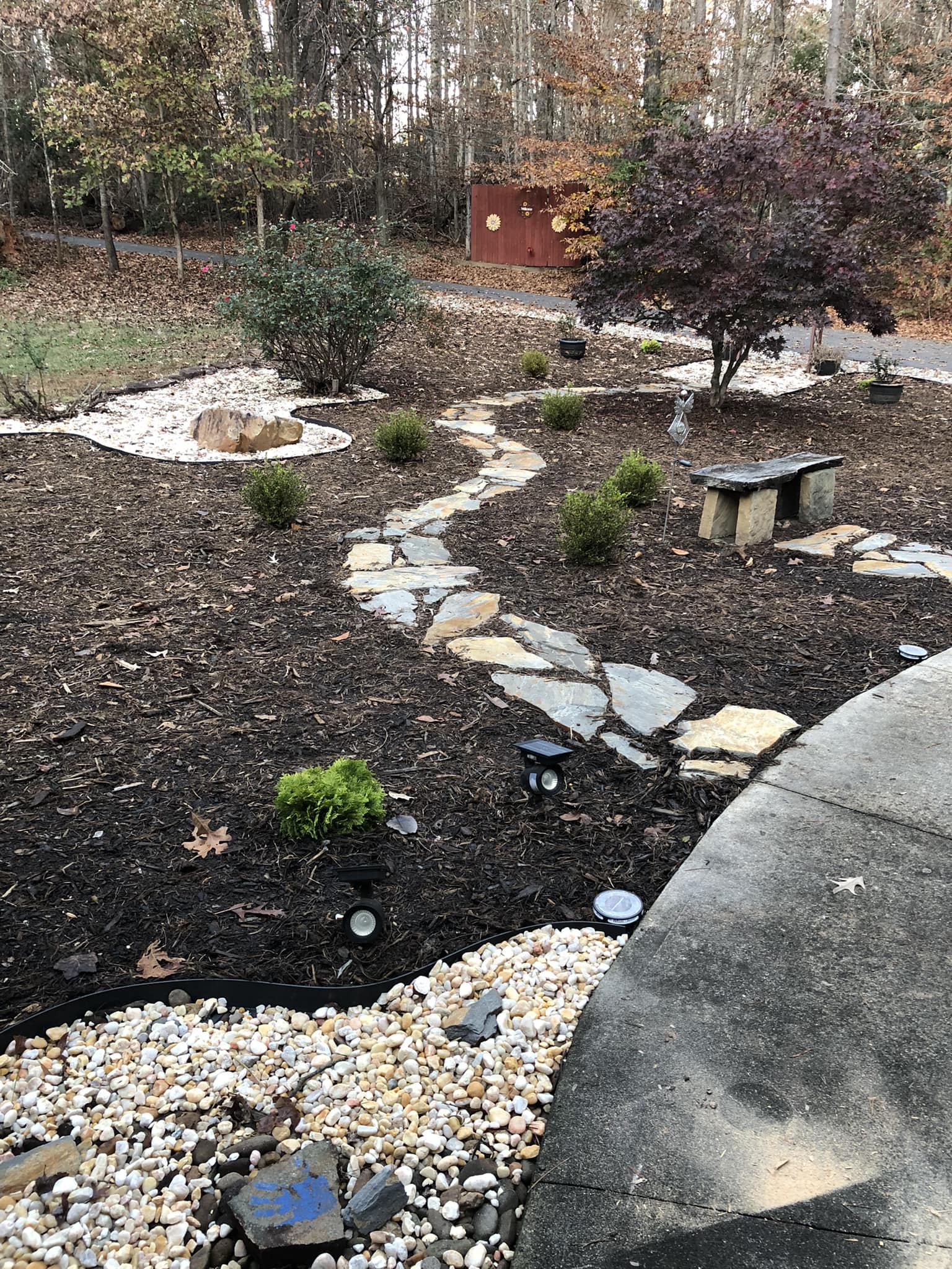 Finished landscape bed and stone path installed by Mooe's Landscaping in Statesville NC